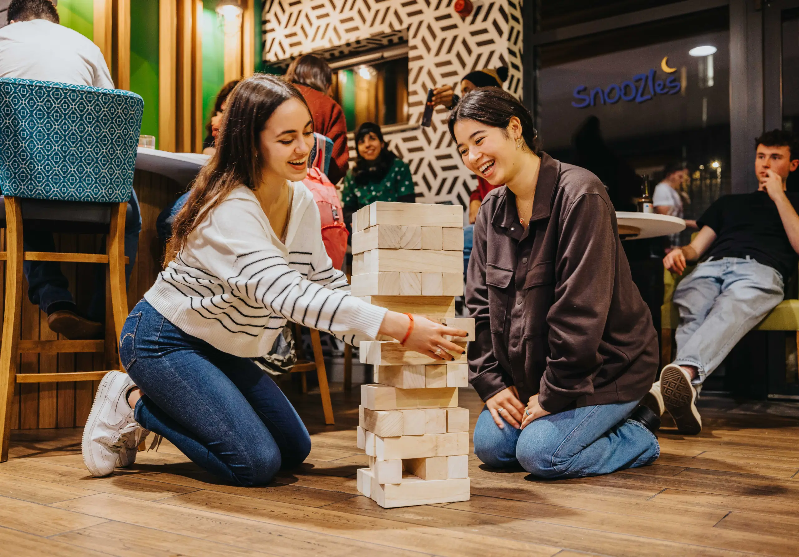 Guests playing board games in a hostel common area